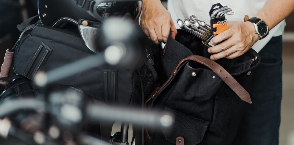 Rider Prepare The Tools And Put Them In Saddlebag Or Side Bag Before On A Trip. Motorcycle Travel Concept. Selective Focus